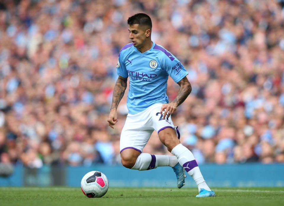 Manchester City's Joao Cancelo heads the ball during the Champions